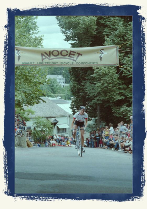 photo of lone bicycle racer crossing finish line