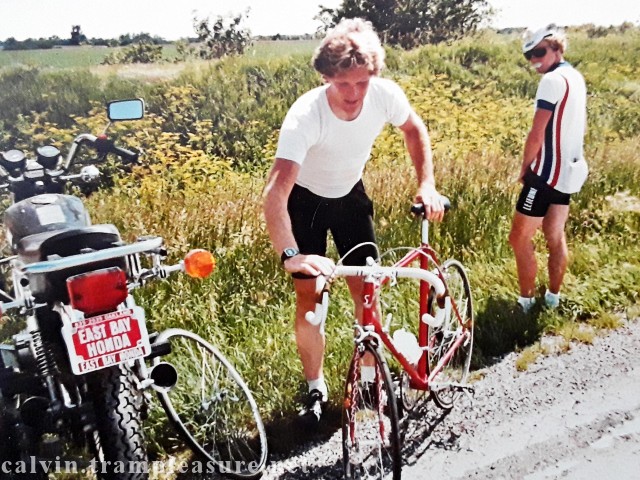 While Tim holds Calvin's bike, Calvin uses the side of the road to urinate