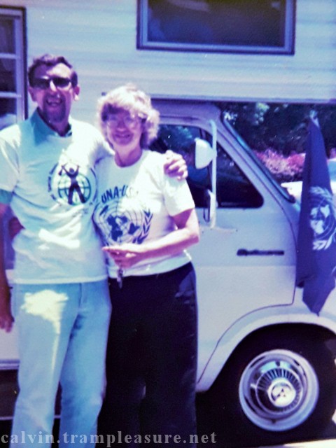 Calvin's mom and dad in front of the motor home with UN flag visible