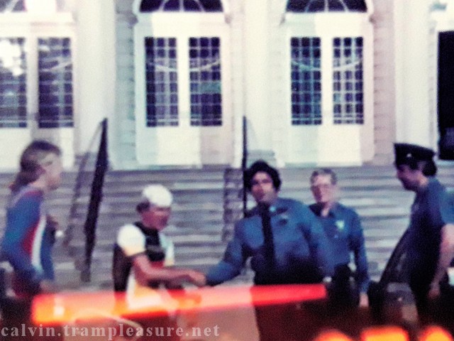 photo of a police officer shaking Calvin's hand in front of NY City Hall